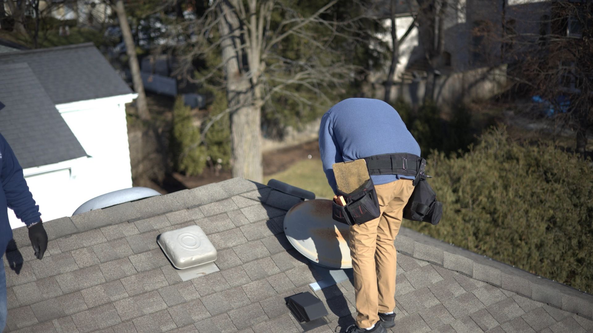 inspecting mushroom vent on a residential roof