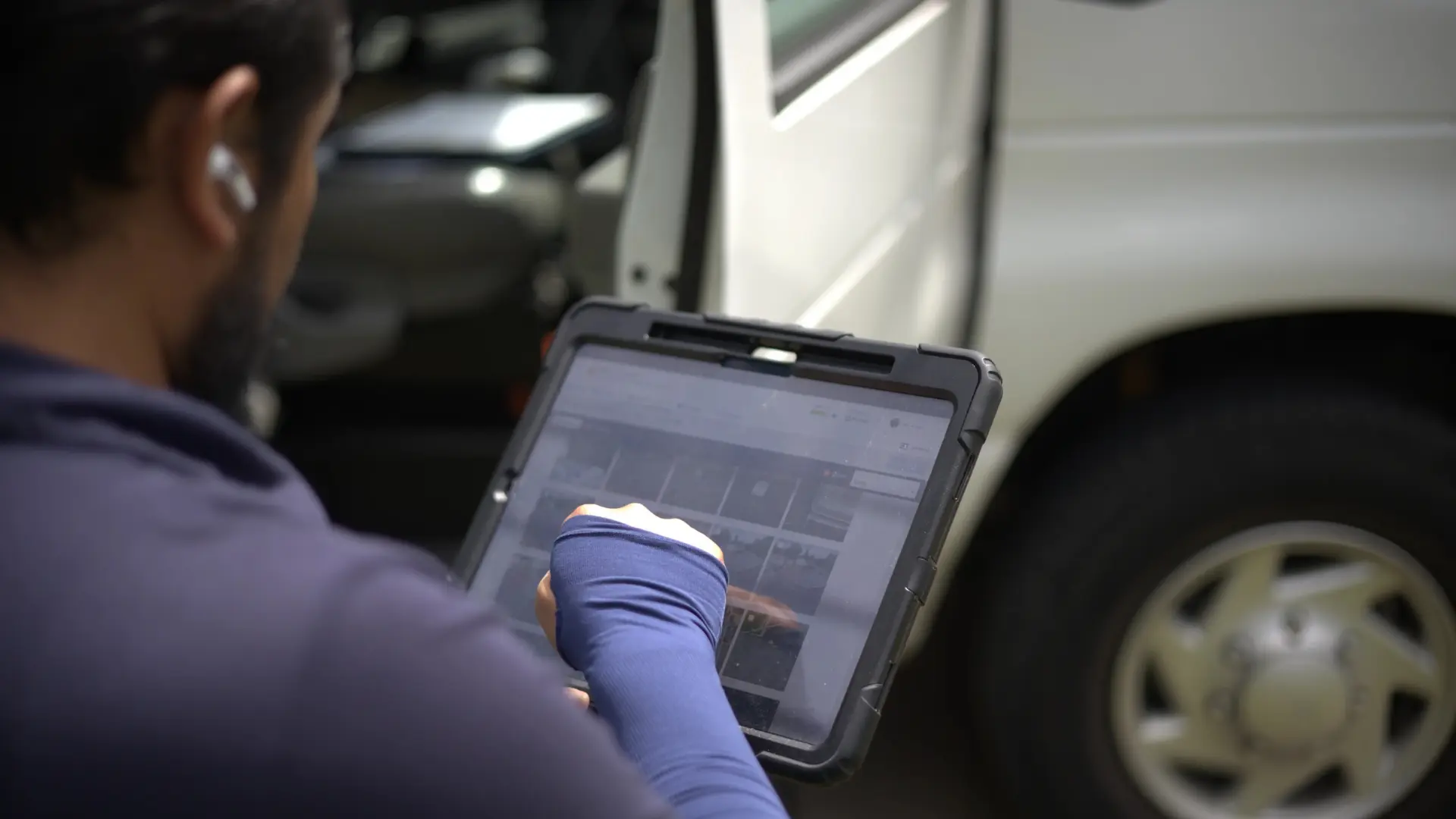 Roofer setting up roofing quote on tablet