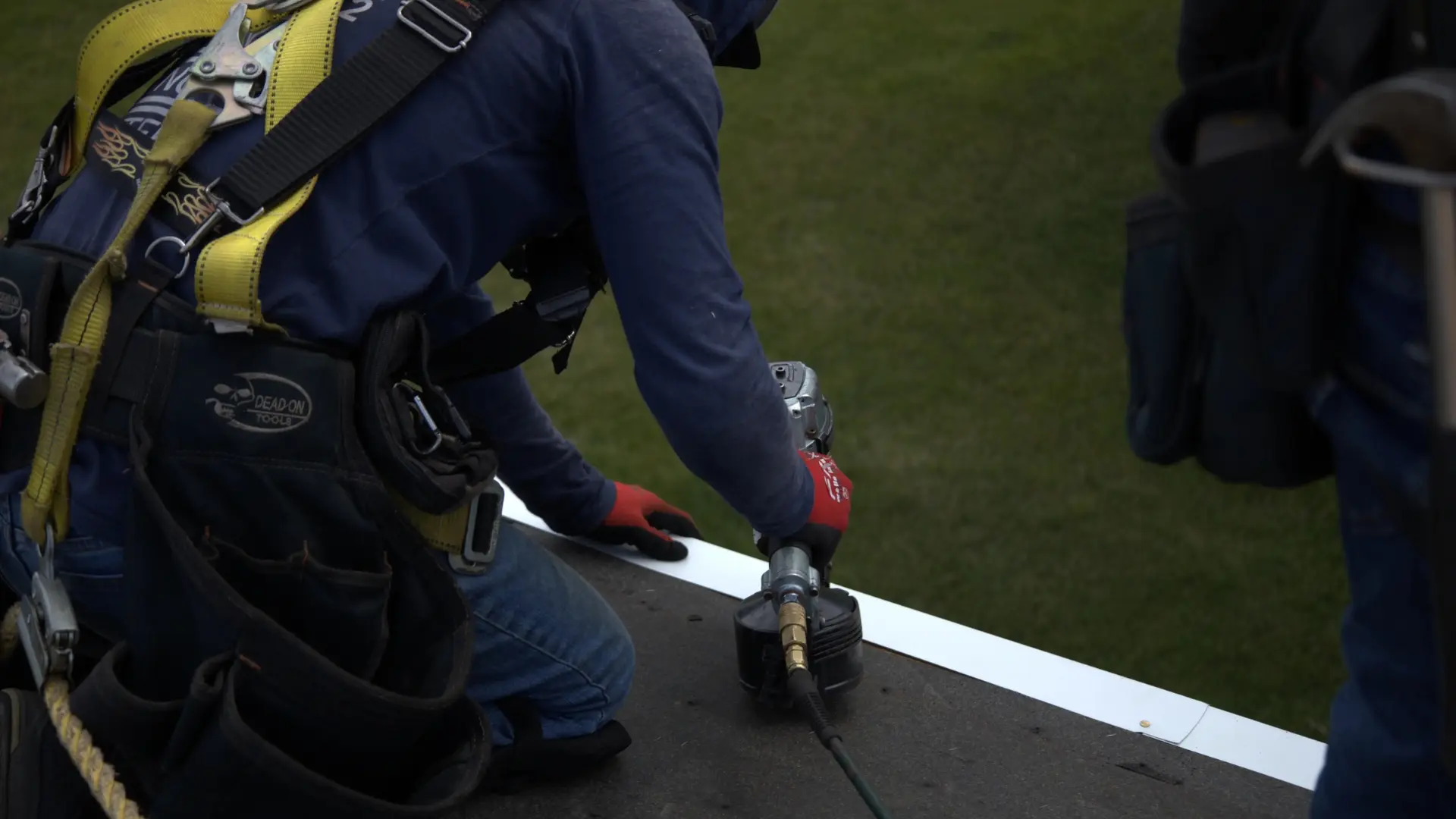 Professional roofer installing drip edge over ice and water shield on a residential roof