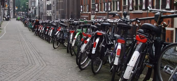 Dutch town bikes lined up on a street in Amsterdam