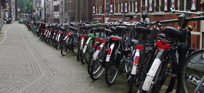 Dutch town bikes lined up on a street in Amsterdam