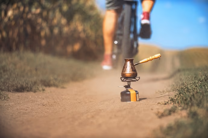 cyclist making coffee on dusty track