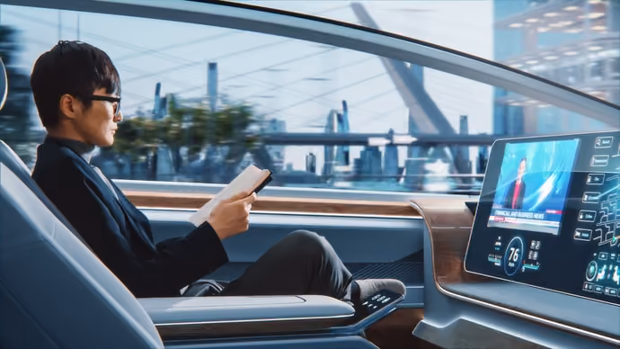 man in driverless car with futuristic streetscape