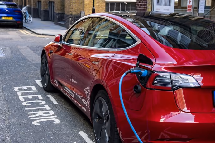 Tesla electric car being charged at roadside