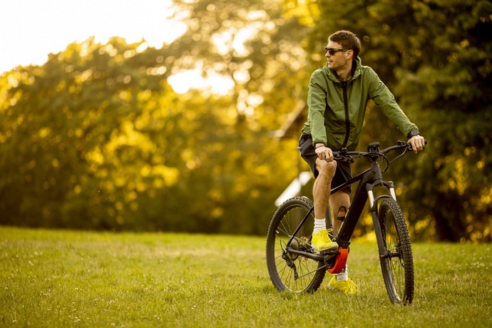 young man riding ebike in the park