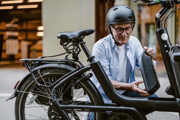 man removing battery from electric cargo bike