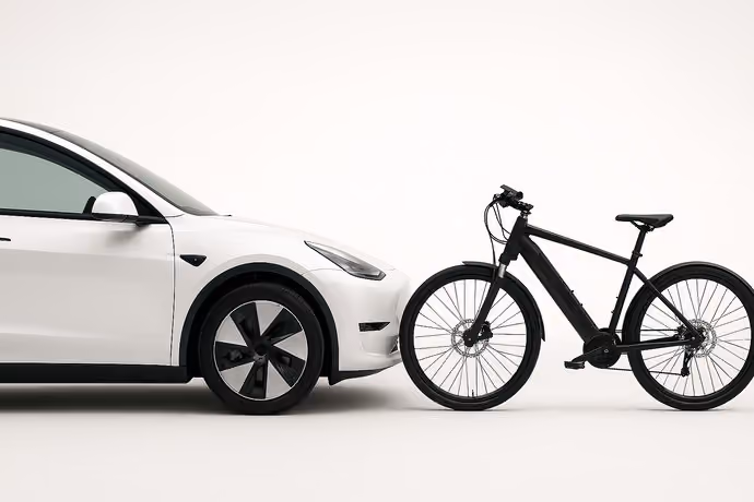 side view of electric car nose to nose with an e-bike
