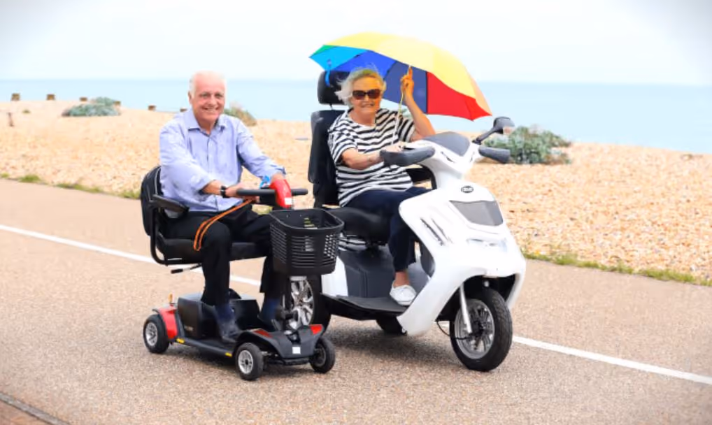 an elderly couple on a class 2 and a class 3 mobility scooter