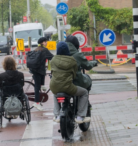 two teenagers riding a fatbike on the pavement