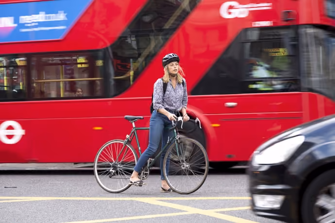 woman cyclist at busy junction in London