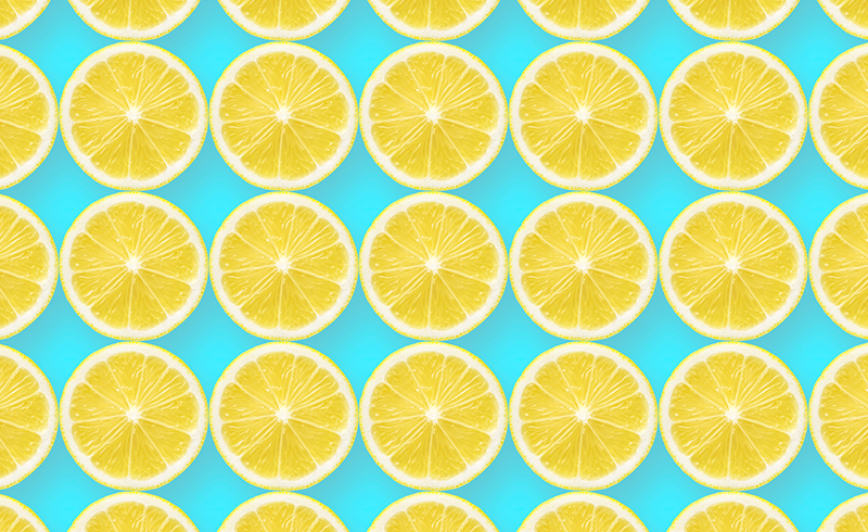 Rows of lemon slices against a light blue backdrop.