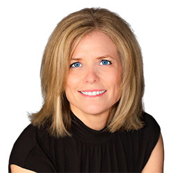 Smiling woman with blonde, shoulder-length hair, wearing a black short sleeve shirt