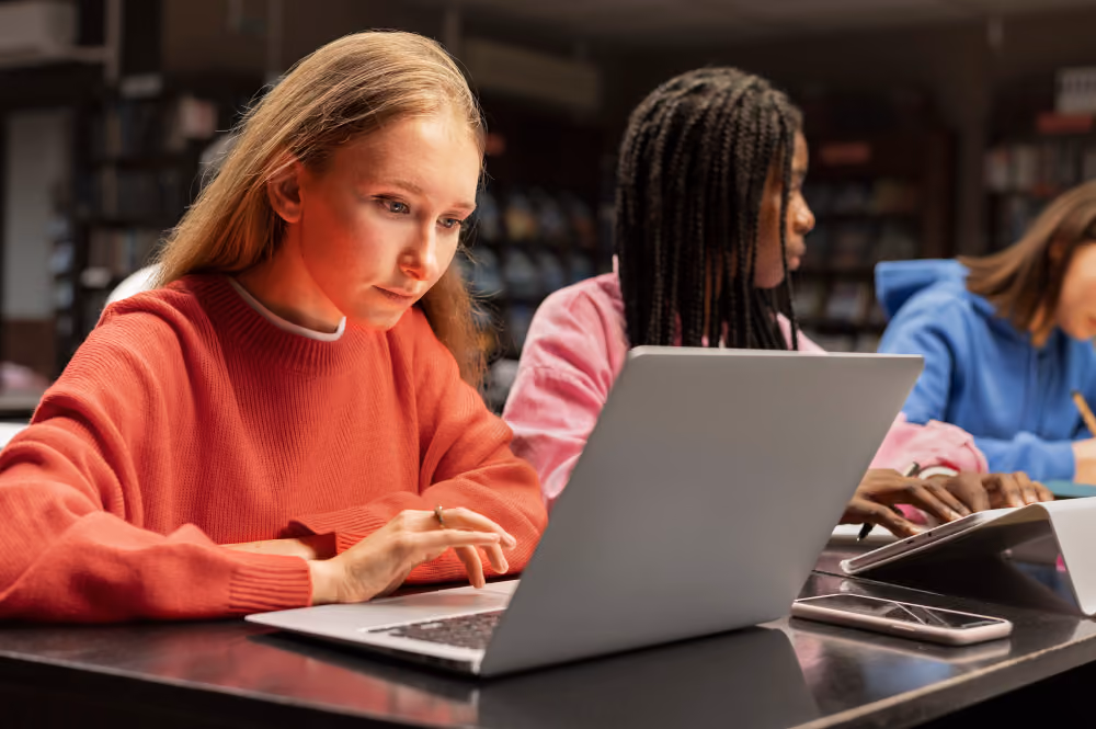 woman working on a laptop - Should Students Use AI