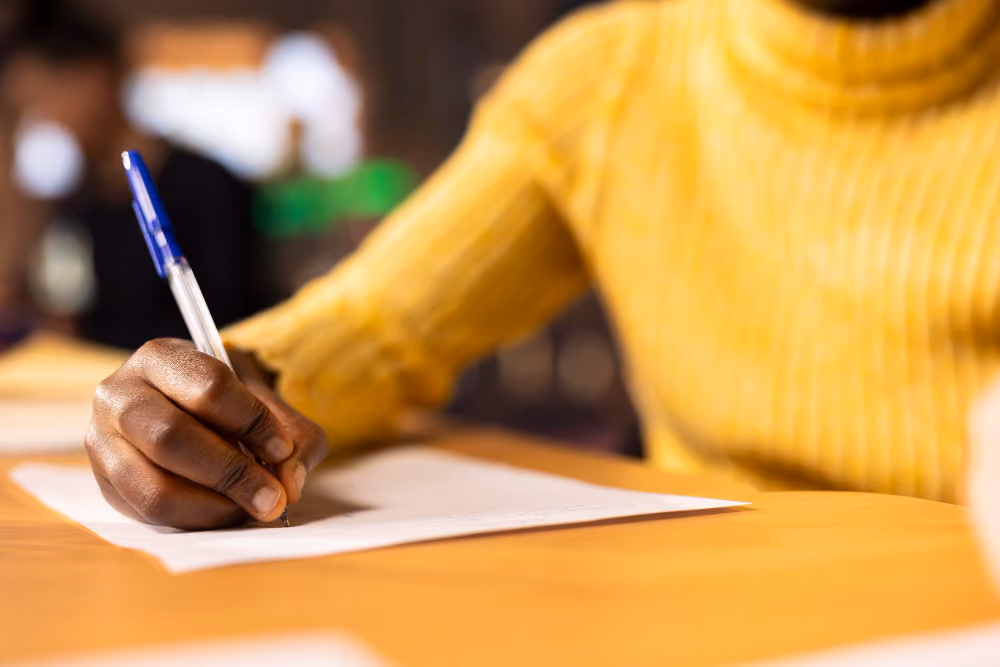woman writing an essay - College Essay Writing Tips
