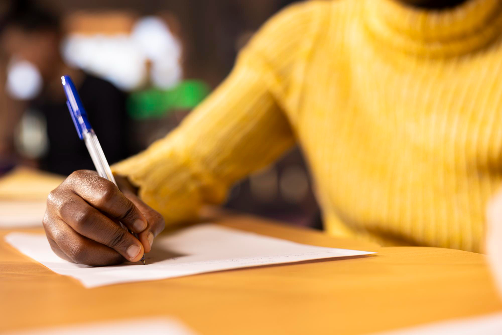 woman writing an essay -  College Essay Writing Tips