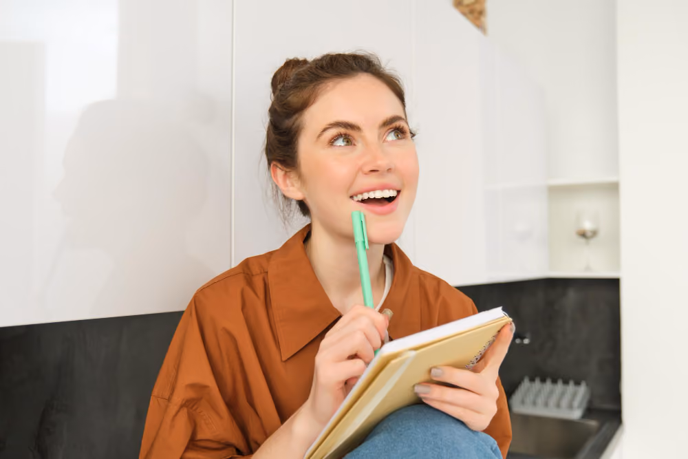 woman thinking and looking happy - Steps to Writing an Essay