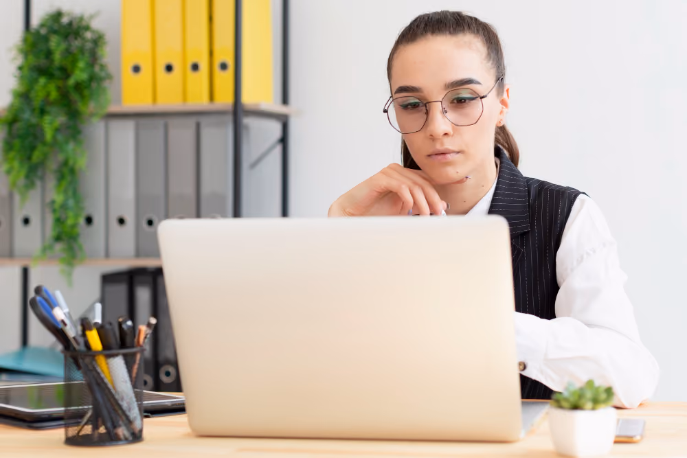 woman using a white laptop - Why Is My Essay Detected as AI