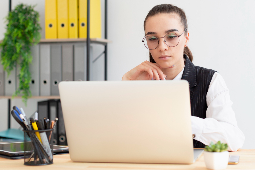 woman using a white laptop - Why Is My Essay Detected as AI
