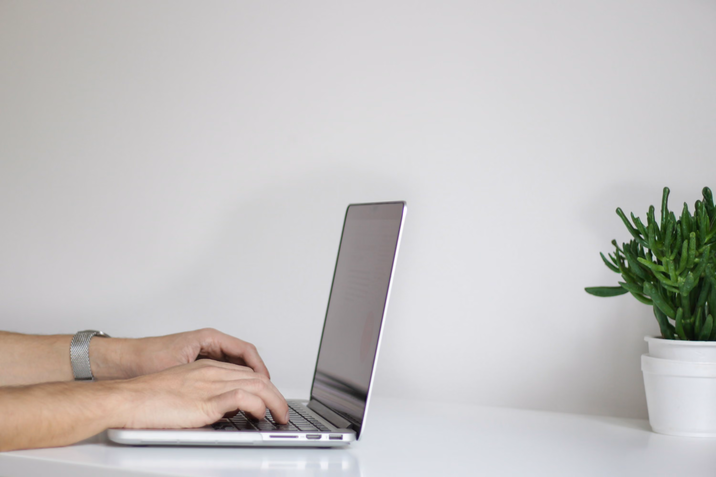 person using laptop - Best AI For Essay Writing