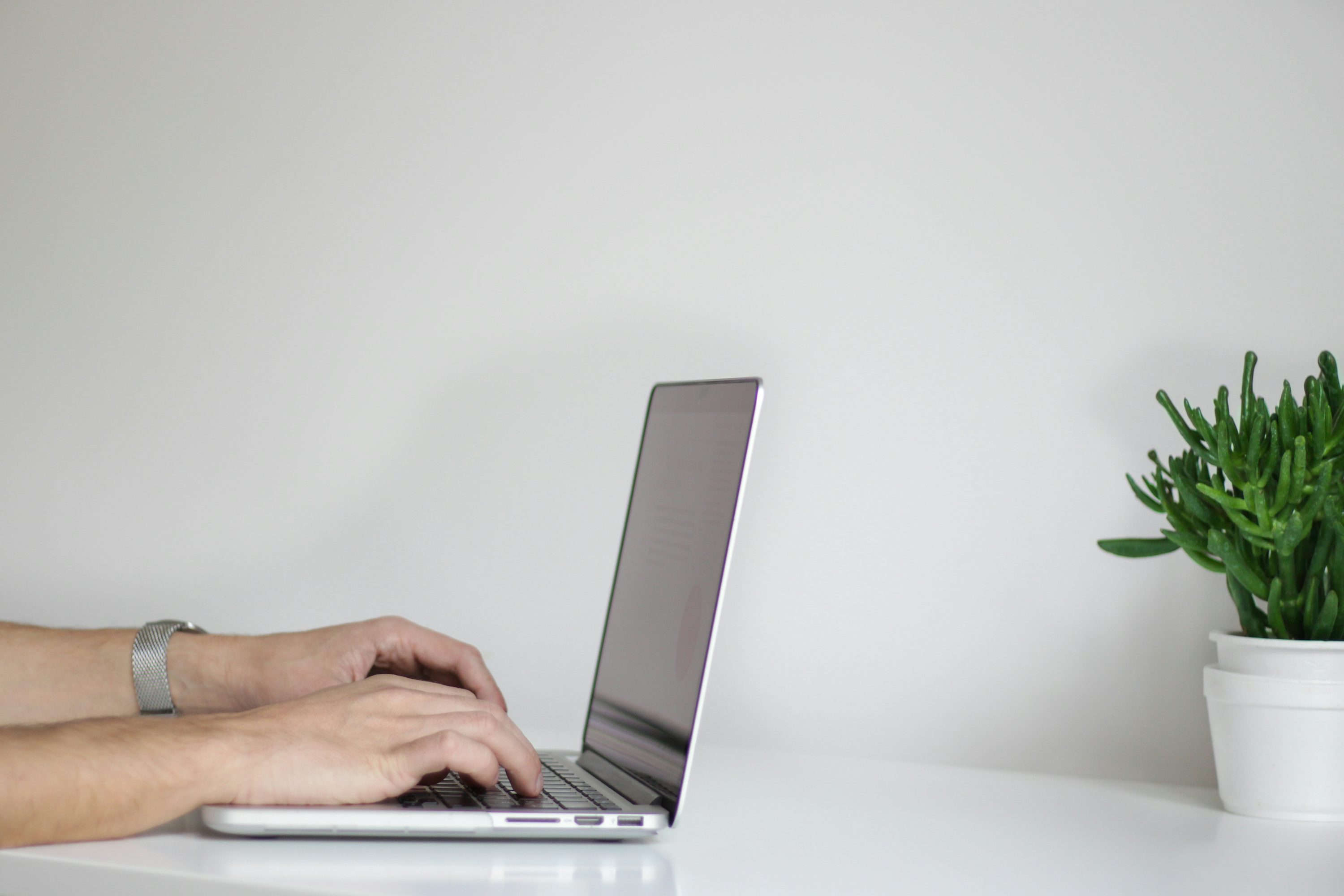 person using laptop - Best AI For Essay Writing