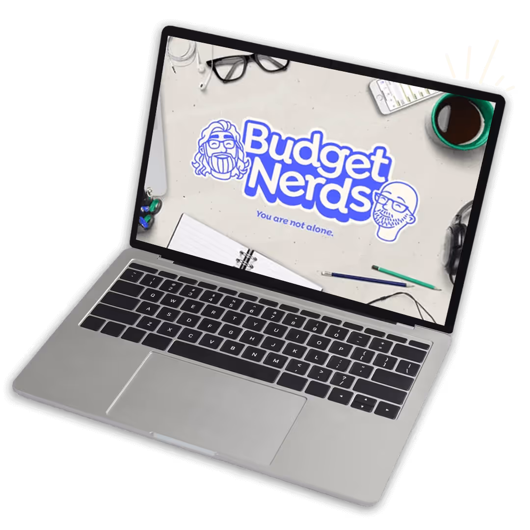 Laptop displaying Budget Nerds logo with cartoon faces, notebook, glasses, coffee cup, pens, and phone on screen background.
