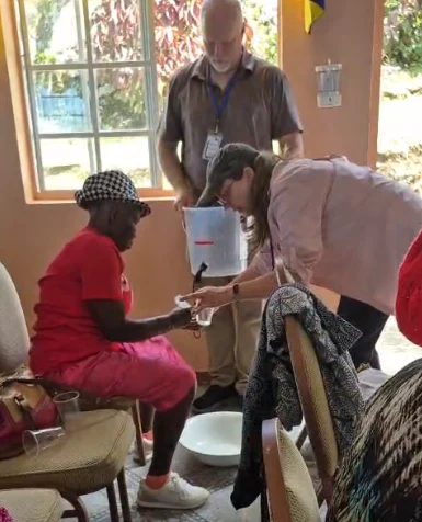 Three people assembling a water filtration system