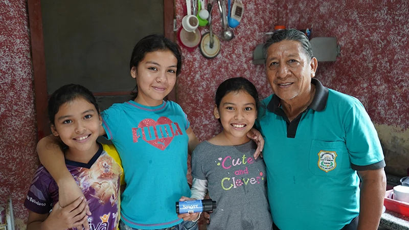 Family of four posing for a photo