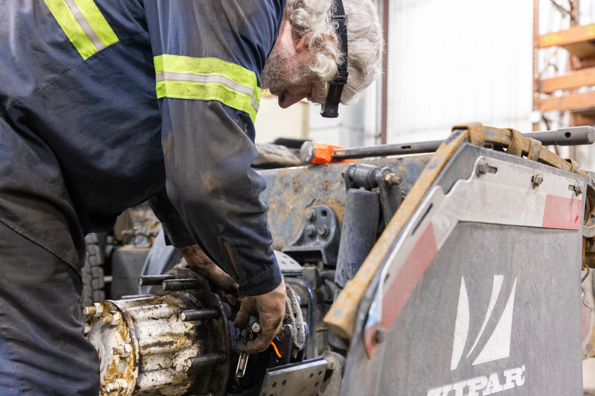 Mechanic repairing farming agricultural equipment in Janesville, WI