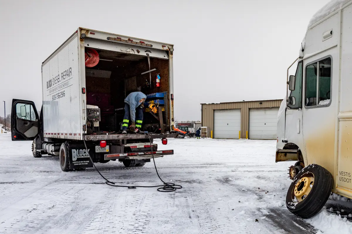 Diesel mechanic performing emergency roadside assistance in Janesville, WI