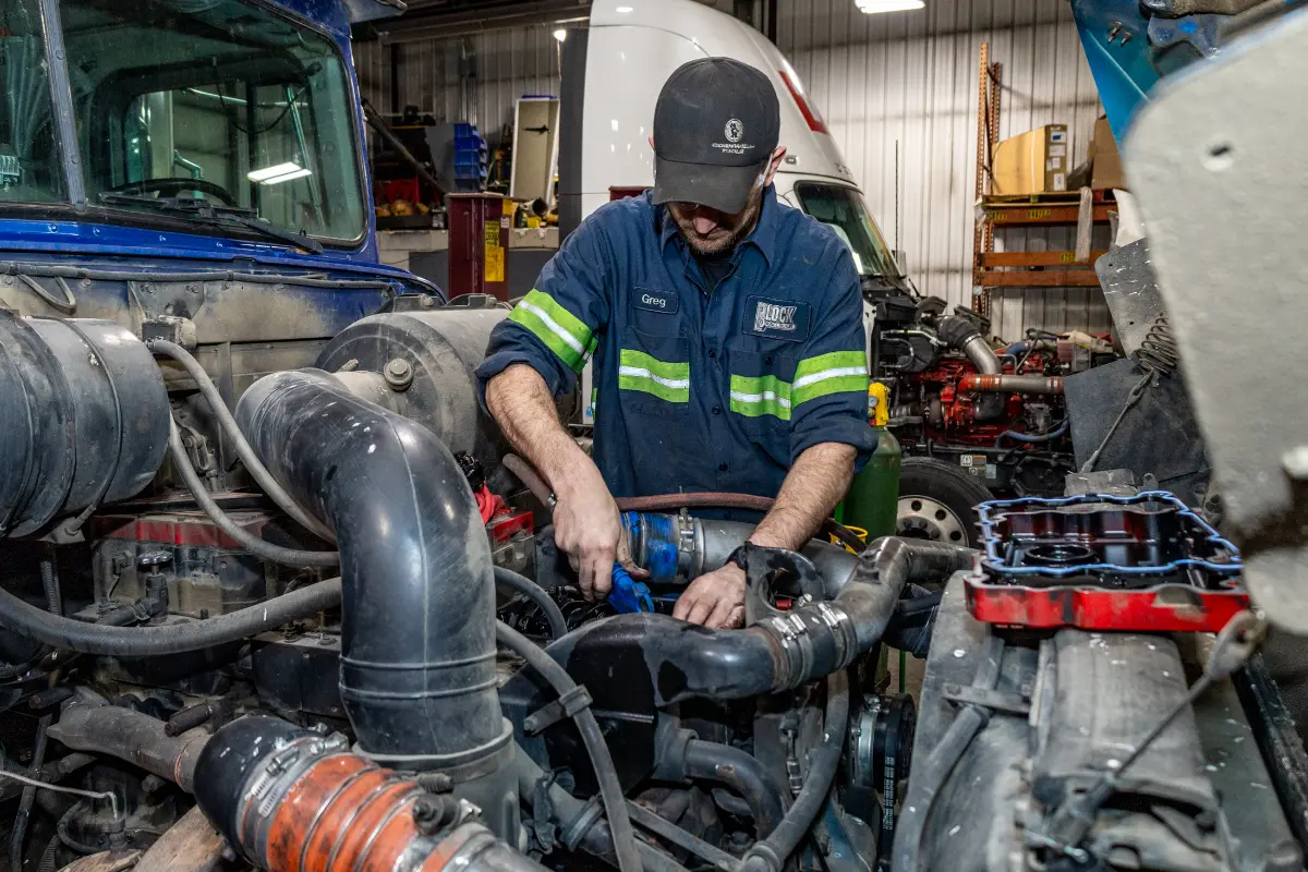 Diesel mechanic performing general diesel repairs on semi truck in Janesville, WI
