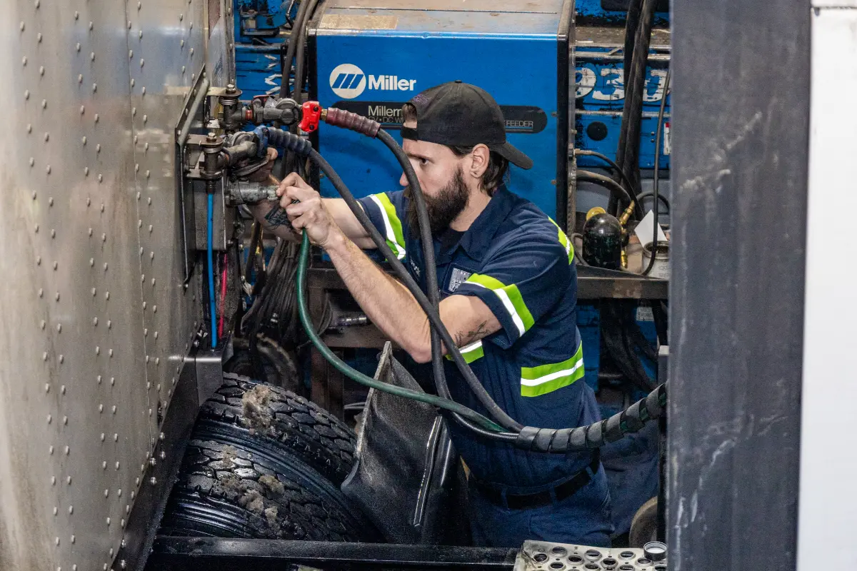 Diesel mechanic providing preventive maintenance services on heavy-duty truck in Janesville, WI