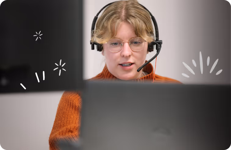 Image of a Crunch team member working at a laptop with a headset on