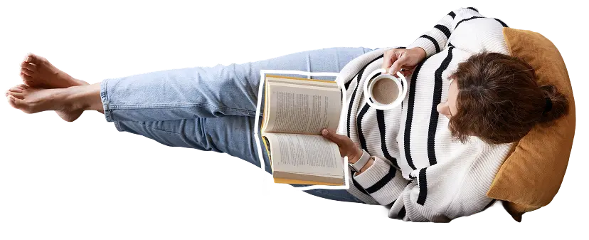 Person lying on a pillow reading a book while holding a cup of coffee. With text: "Put your feet up whilst we take care of your tax!"