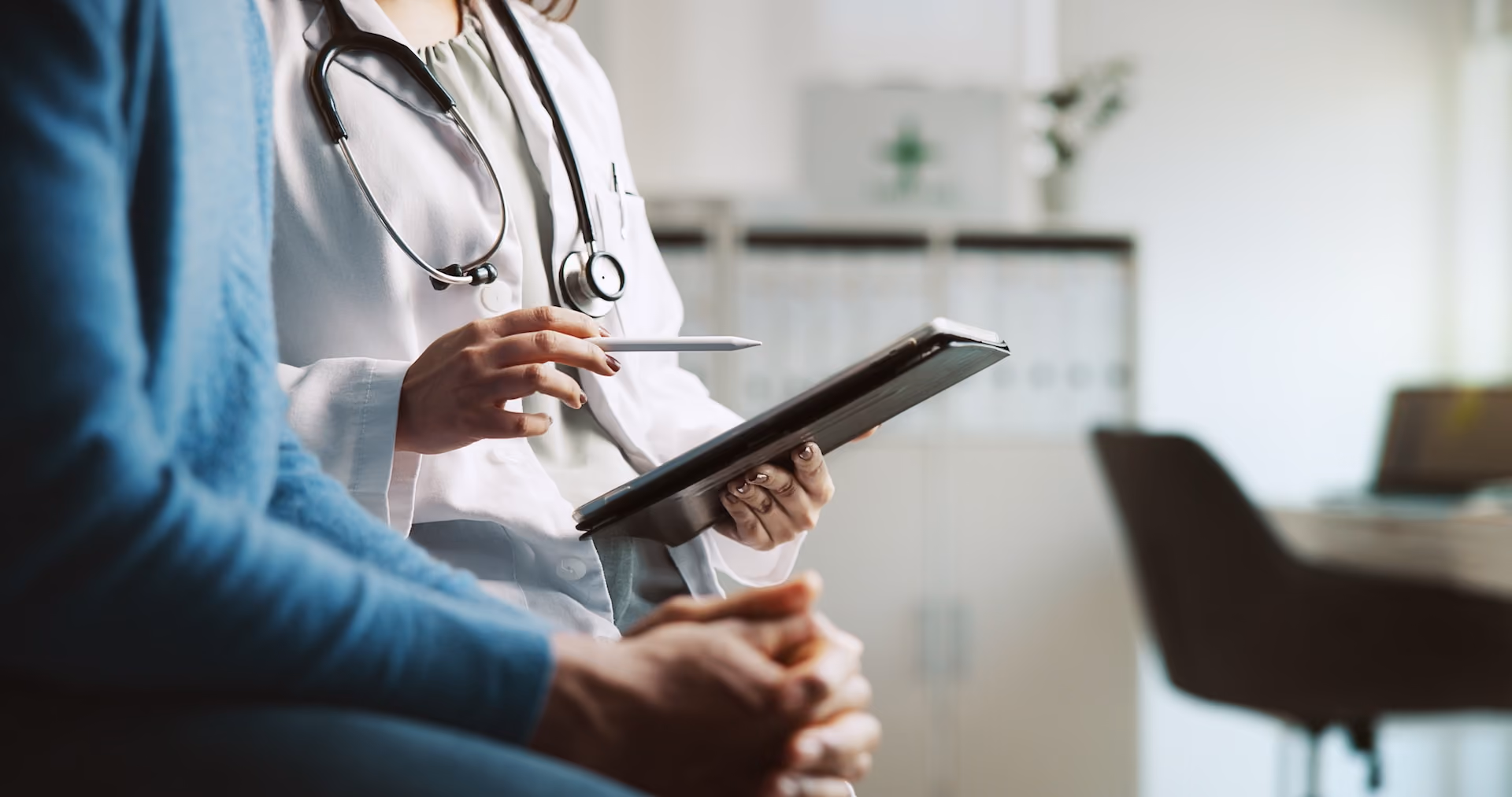A medical professional holding a tablet