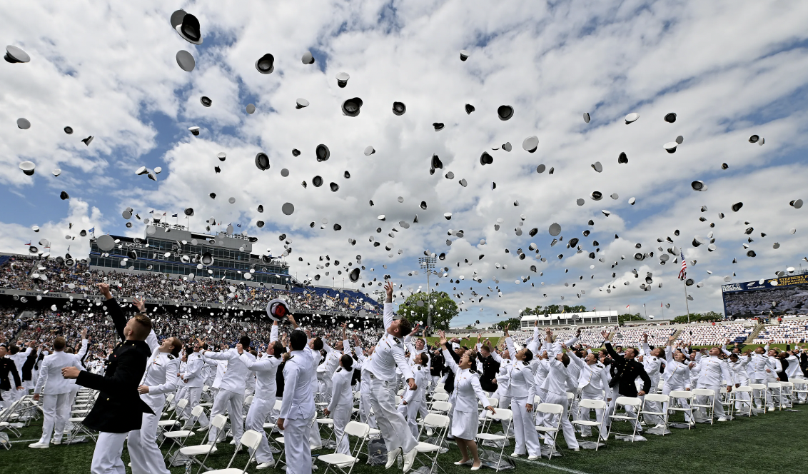 A group of people throwing hats in the airAI-generated content may be incorrect.