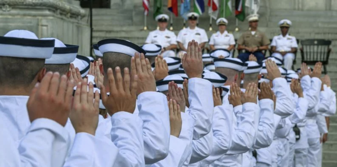 A group of people in white uniforms salutingAI-generated content may be incorrect.