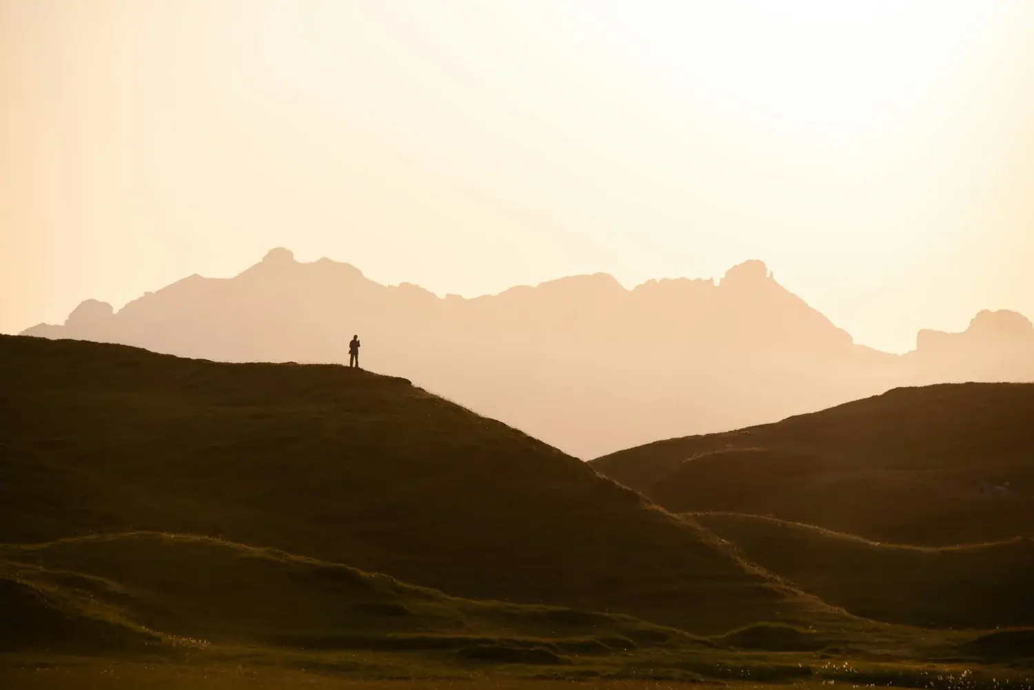 A lone figure on a ridge at dawn