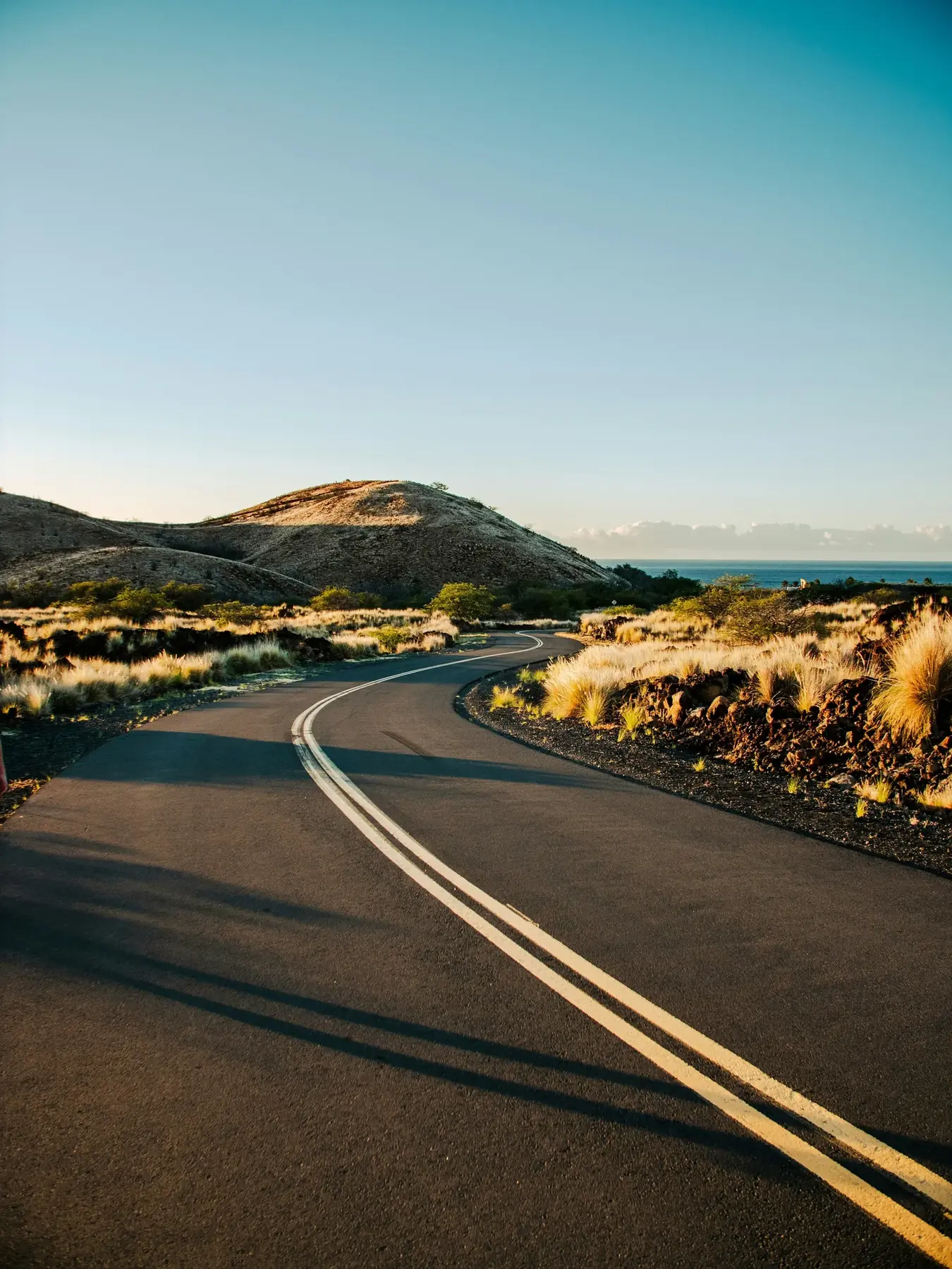 A road winding towards distant hills