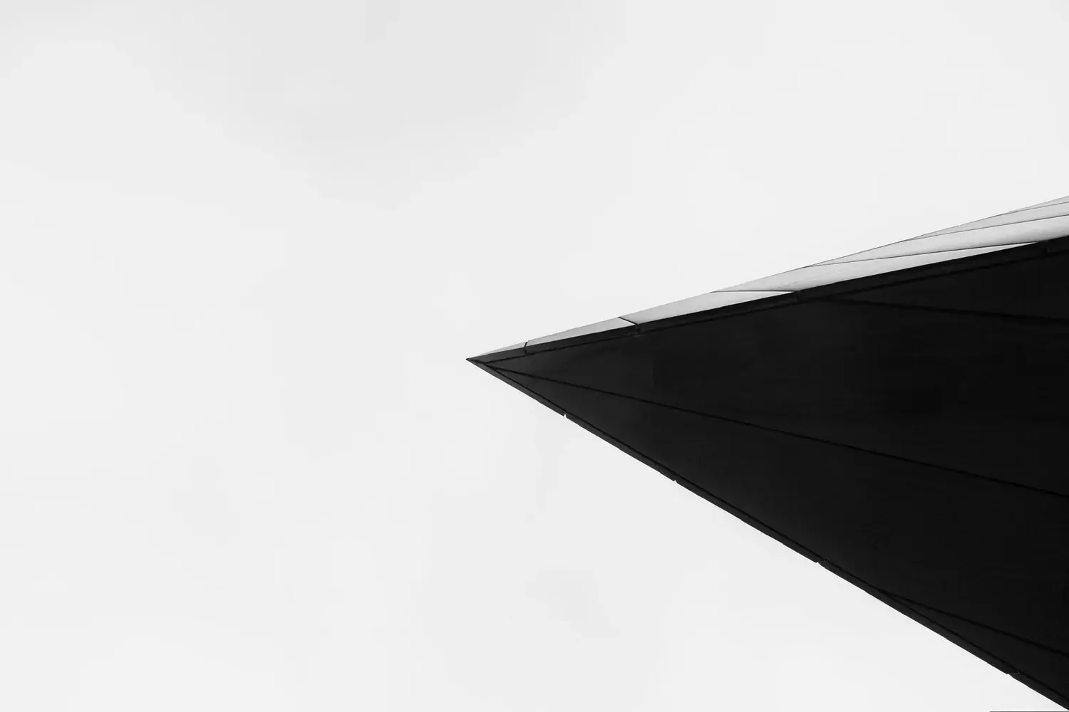 The sharp edge of a dark building against the sky