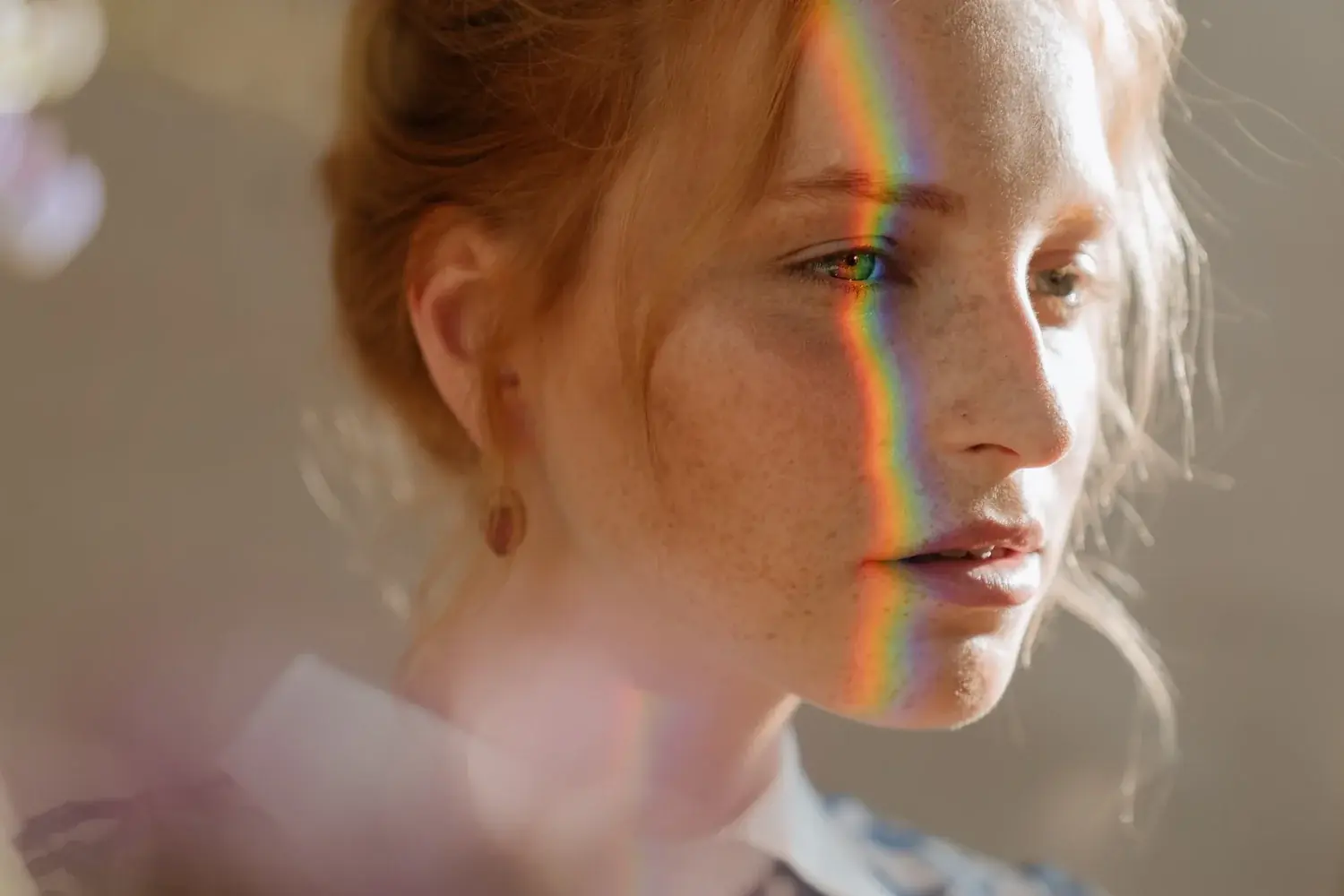 A face lit by a spectrum of refracted light