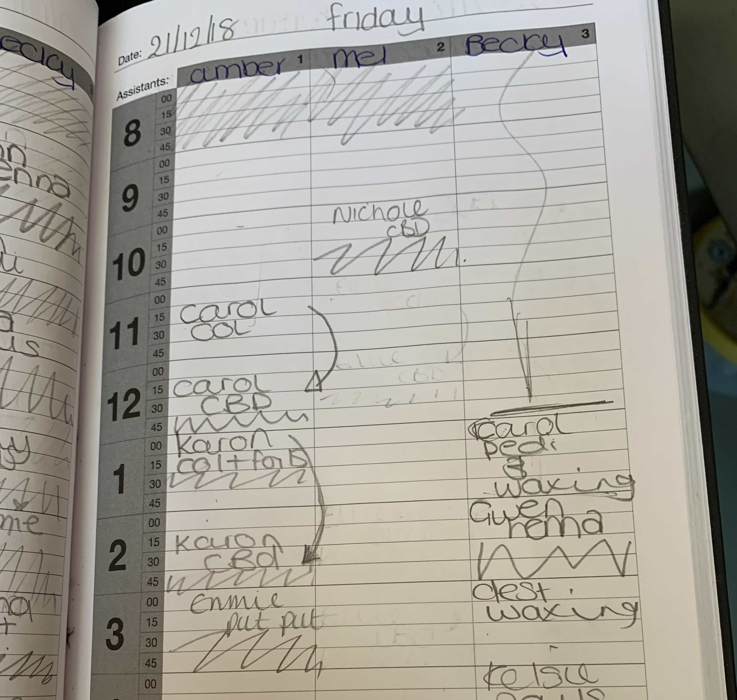 Handwritten paper appointment diary full of crossed-out bookings