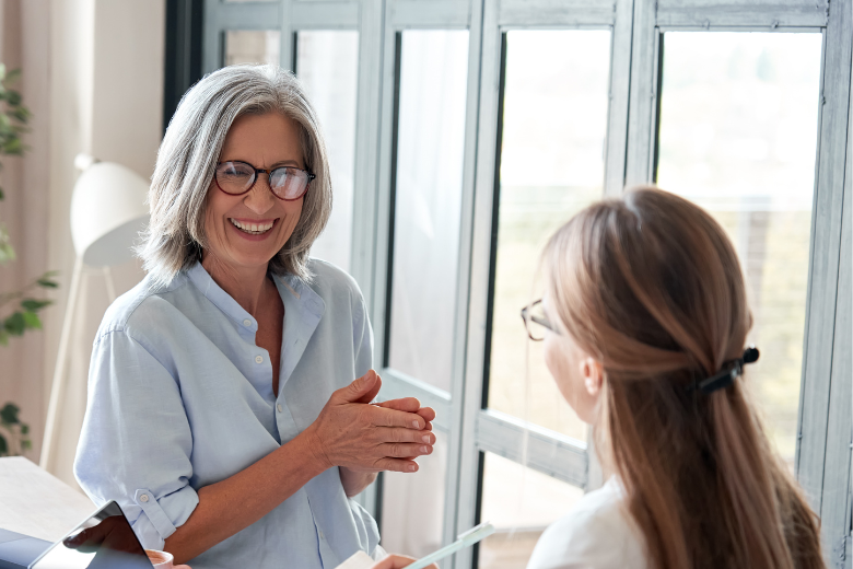 Smiling manager talking with an employee in a one-to-one meeting