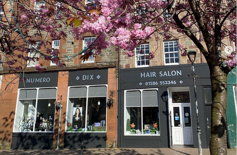 Numero Dix hair salon shopfront, with cherry blossom trees outside