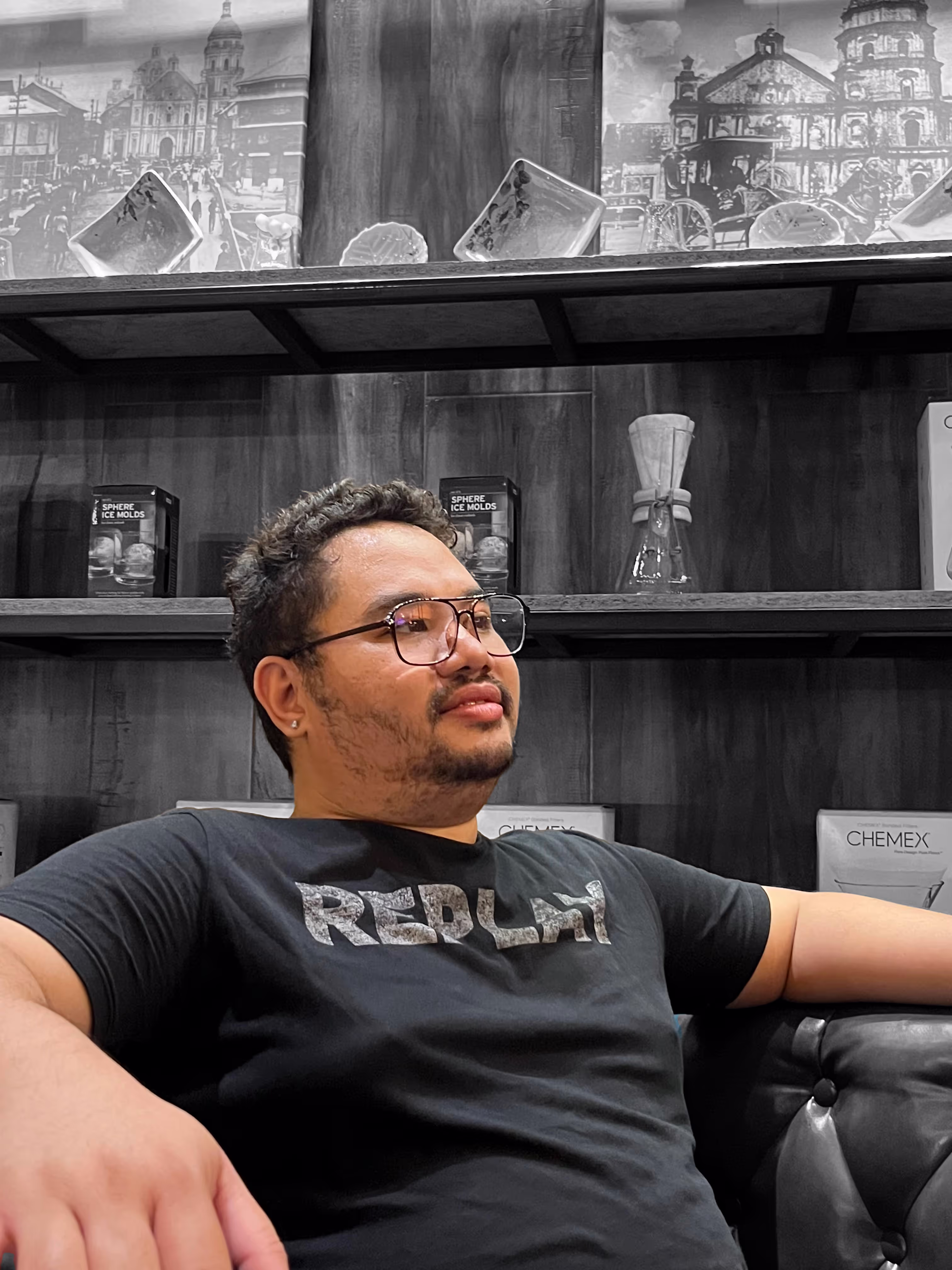 A image of a man wearing glasses who looks good with a grayscale background