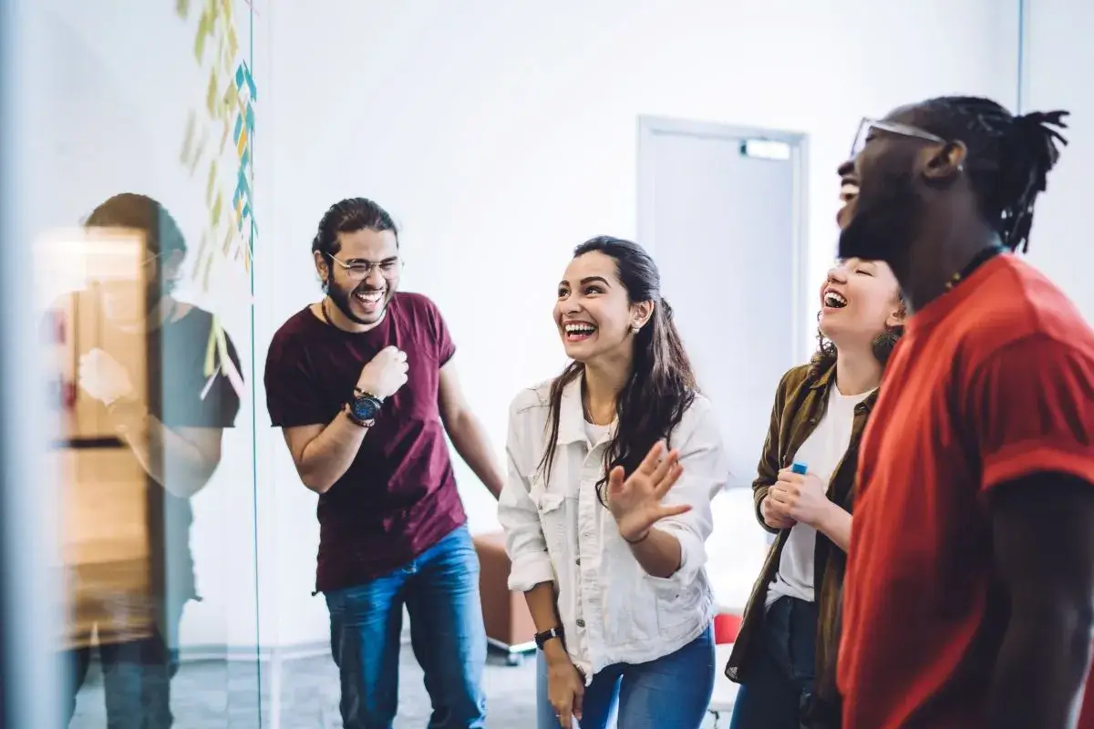 Group of people standing and collaborating.