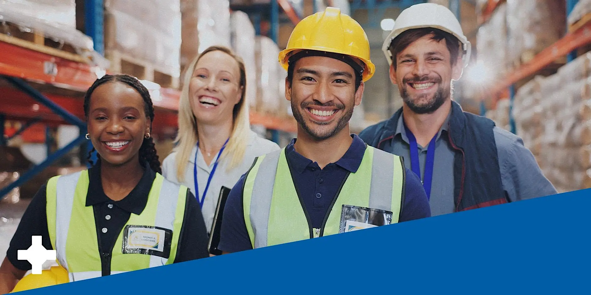 Group of four people wearing yellow vests inside a manufacturing facility with a blue triangle representing the Manufacturing Nevada brand colors at the bottom.