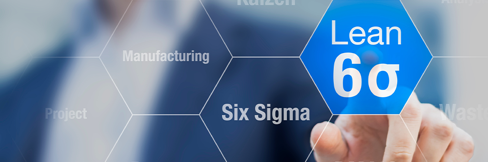 A man points a finger towards a honeycomb grid overlay, that includes words related to Lean Six Sigma. His finger rests on the words "Lean Six Sigma".
