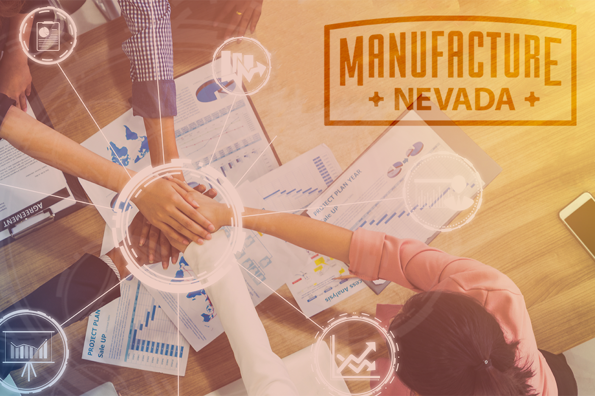 Hands join in the center of a table covered in business papers showing graphs, planning, maps, and a business agreement. Manufacture Nevada logo is overlaid in the corner.