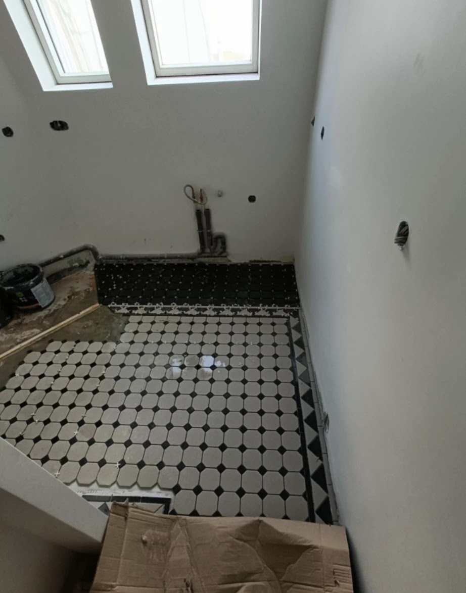 Pose du carrelage octogonal noir et blanc dans une pièce d’eau