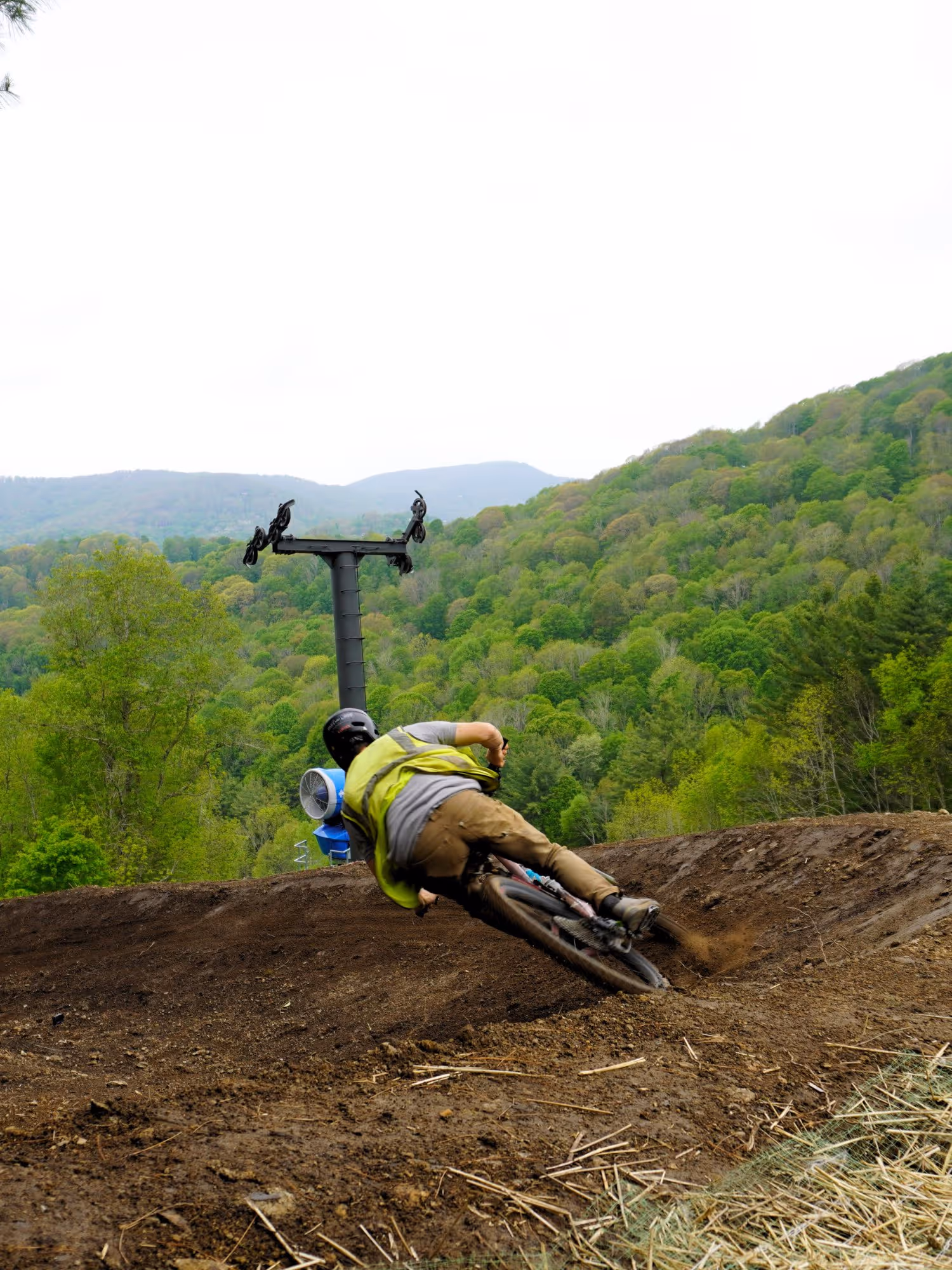Mountain biking going down hill through forest